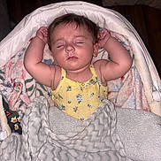 Brynleigh joined the competition — help win amazing prizes! baby, sleeping, blanket, bassinet, yellow_clothing, floral_pattern, cozy, infant, arms_up, soft_texture, peaceful, child, indoors, head, face, cute, resting, comfort, toddler, portrait