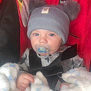 Wesley is registered to the contest to win money with this photo: baby, beanie, blanket, bonnet, cap, car, car_interior, clothing, couch, face, furniture, glove, hat, head, newborn, person, photography, portrait, transportation, vehicle