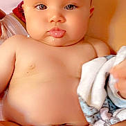 Yannice André participe au concours pour gagner de l'argent avec cette photo : baby, infant, diaper, chubby_cheeks, tongue_out, closeup, portrait, eyes, skin, towel, blanket, pillow, torso, hand, cute, adorable, indoors, sitting, expression, face