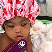 Lea joined the competition — help win amazing prizes! baby, blanket, calm, candid, child, closeup, curly_hair, expression, face, headwear, indoors, person, pink, portrait, shower_cap, skin, sleepy, soft_texture, strawberry_pattern, toddler