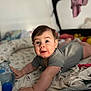 baby, bed, blanket, child, clothing, cozy, curious, cute, face, happy, home, indoors, infant, person, reaching, smiling, soft_light, toddler, toy, water_bottle