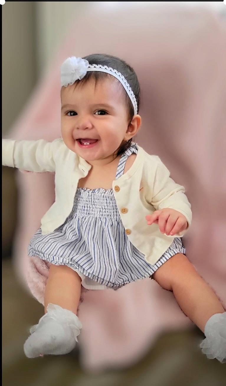 Aria is registered to the contest to win money with this photo: baby, baby_toddler_clothing, cap, child, face, fashion_accessory, flash_photography, fun, gesture, happy, headband, headpiece, headwear, joy, outerwear, person, pink, skin, sleeve, smile