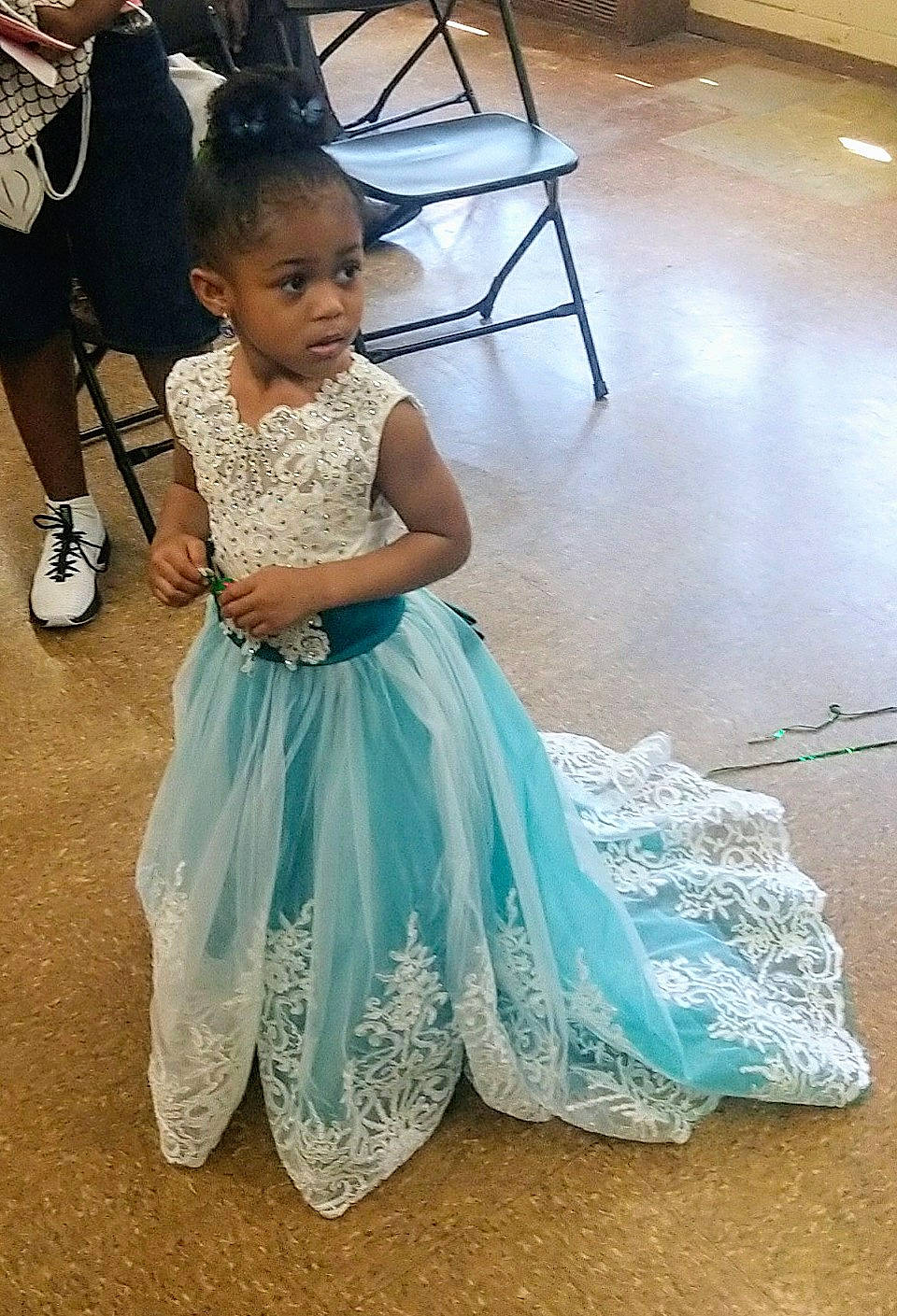 Jewel is registered to the contest to win money with this photo: a_line, bridal_party_dress, ceremony, child, child_model, clothing, costume, dress, fashion, fashion_design, flooring, flower_girl, formal_wear, gown, lace, person, smile, toddler, turquoise