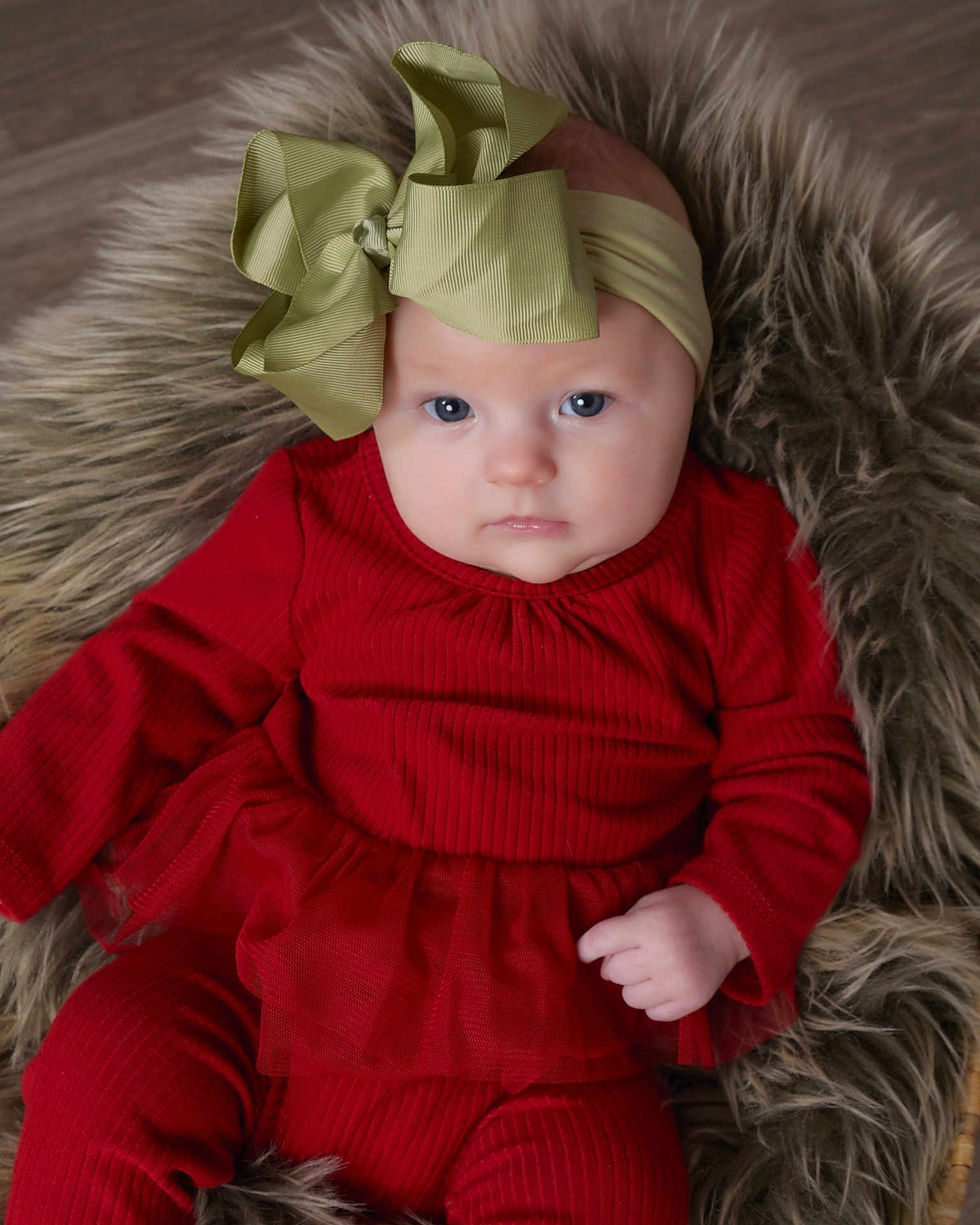 Kinsley joined the competition — help win amazing prizes! baby, infant, child, red_clothing, headband, bow, fur_rug, portrait, blue_eyes, cute, tulle_skirt, long_sleeves, cozy, soft_texture, lying_down, indoor, close_up, person, adorable, young_child