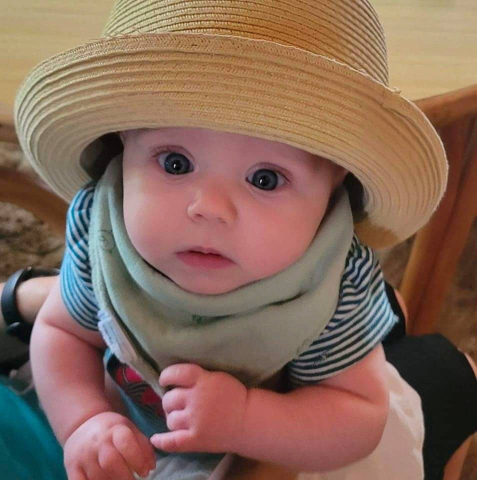 Althea is registered to the contest to win money with this photo: baby, baby_toddler_clothing, cap, cheek, child, comfort, costume_hat, eye, fashion_accessory, fedora, fun, happy, hat, headwear, lip, mammal, person, sitting, skin, sun_hat