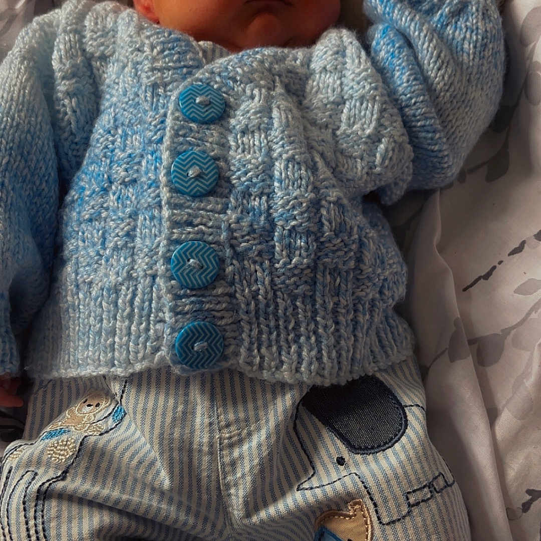 George-Thomas is registered to the contest to win money with this photo: baby, blanket, blue_sweater, child, cozy, cute, fabric, hand, indoors, infant, knitted, newborn, patches, peaceful, portrait, resting, sleeping, soft_lighting, striped_pants, textile