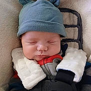 Waylon is registered to the contest to win money with this photo: baby, sleeping, hat, cozy, blanket, child, infant, cute, warm, soft, face, clothing, bundle, resting, car_seat, comfort, adorable, headwear, peaceful, toddler