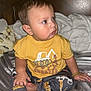 Azarias joined the competition — help win amazing prizes! toddler, child, yellow_shirt, construction_vehicle, sitting, bed, blanket, wooden_headboard, blue_eyes, curious, indoor, pants, foot, hand, bracelet, cozy, soft_texture, portrait, baby, casual_clothing