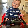 Arthur joined the competition — help win amazing prizes! child, toddler, blue_eyes, smiling, toy_car, indoor, striped_sweater, steering_wheel, red, seatbelt, wooden_floor, cute, short_hair, person, happy, play, small_vehicle, seat, casual_clothing, baby