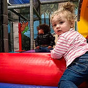 Jazara is registered to the contest to win money with this photo: baby, clothing, coat, face, footwear, head, indoorplayarea, indoors, inflatable, jeans, outdoorplayarea, outdoors, pants, person, photography, playarea, portrait, shoe, slide, toy