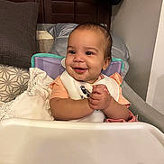 Kensley joined the competition — help win amazing prizes! baby, bib, child, clapping, clothing, cute, face, feeding, furniture, hands, happy, high_chair, home, indoor, infant, person, pillow, seat, smiling, table