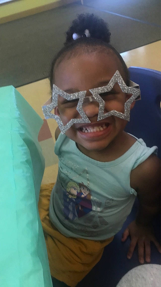 Ariella is registered to the contest to win money with this photo: cheek, chin, eyebrow, eyelash, eyewear, forehead, goggles, happy, iris, jaw, joy, mouth, neck, nose, person, personal_protective_equipment, skin, sleeve, smile, sunglasses