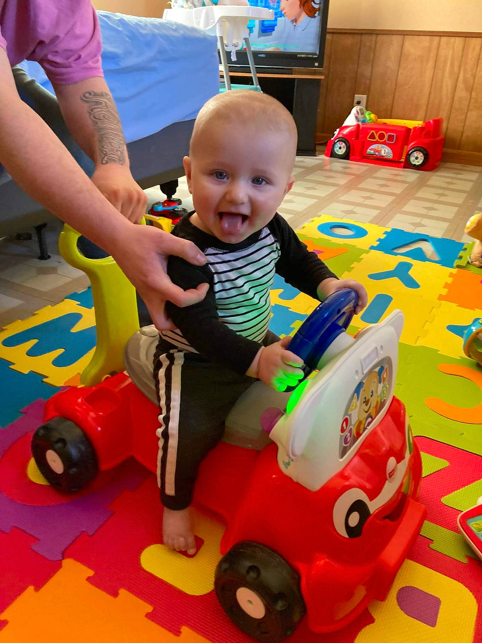 Jaiveon joined the competition — help win amazing prizes! baby, baby_playing_with_toys, baby_products, child, event, flooring, fun, leisure, person, play, recreation, red, riding_toy, shorts, smile, tire, toddler, toy, vehicle, wheel