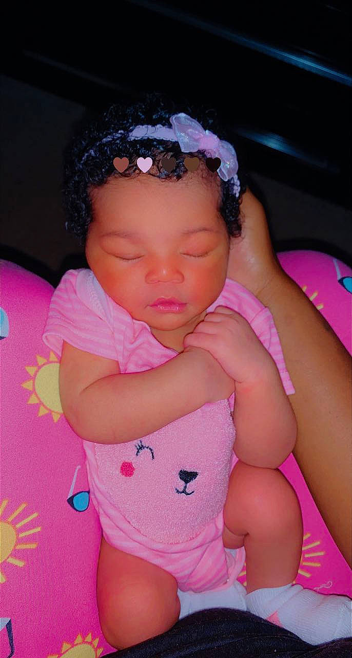 Malani is registered to the contest to win money with this photo: arm, baby_toddler_clothing, beauty, cheek, child, eyelash, facial_expression, finger, fun, happy, headwear, lip, magenta, nose, person, pink, purple, skin, textile, thigh