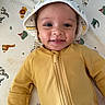 Malakai is registered to the contest to win money with this photo: baby, smile, hat, yellow_outfit, animal_pattern, blanket, giraffe, zebra, lion, crocodile, baby_clothing, happy, portrait, infant, cute, lying_down, child, face, closeup, playful_background