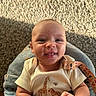 baby, infant, smile, blanket, carpet, sunlight, shadow, clothing, giraffe_print, zebra_print, face, happy, cute, indoors, person, skin, hand, warm_light, closeup, portrait