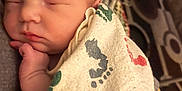 Luna is registered to the contest to win money with this photo: newborn, baby, sleeping, blanket, footprints, hand, face, infant, cozy, resting, closeup, soft, cute, wrapped, peaceful, portrait, skin, human, child, indoors