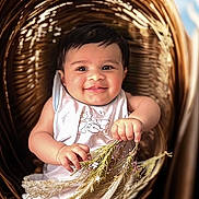 Ayan participe au concours pour gagner de l'argent avec cette photo : baby, infant, smiling, face, hand, flower, basket, wicker, dried_flower, cute, child, portrait, happy, indoors, person, clothing, white_outfit, skin, head, sitting