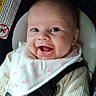 baby, baby_boy, baby_girl, bib, car_seat, child, closeup, clothing, cute, face, happy, head, human, indoors, infant, infant_clothing, portrait, safety, seatbelt, smiling