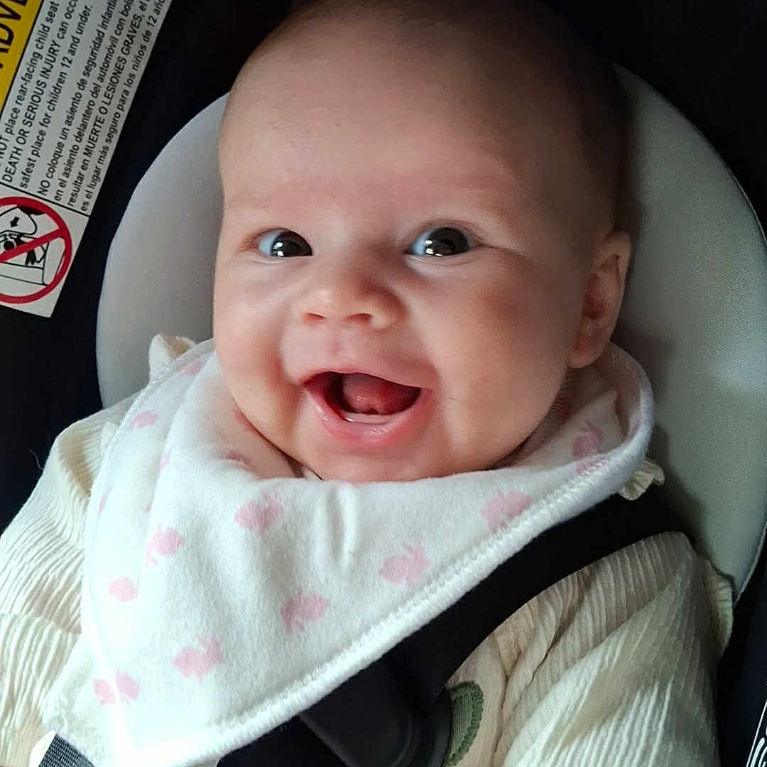 Ginna joined the competition — help win amazing prizes! baby, baby_boy, baby_girl, bib, car_seat, child, closeup, clothing, cute, face, happy, head, human, indoors, infant, infant_clothing, portrait, safety, seatbelt, smiling