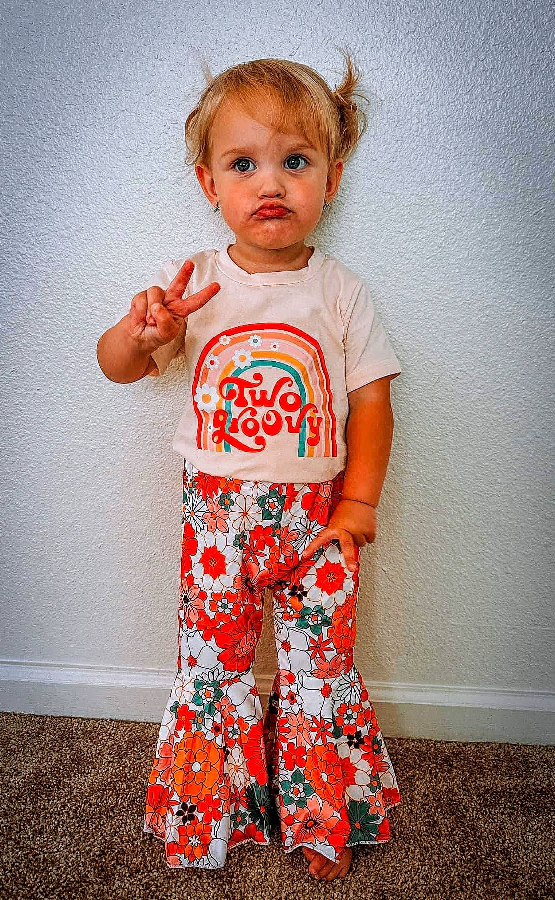 Quinn is registered to the contest to win money with this photo: arm, baby_toddler_clothing, child, day_dress, electric_blue, face, fashion_design, happy, neck, one_piece_garment, orange, pajamas, pattern, peach, person, shoulder, sleeve, t_shirt, toddler, top
