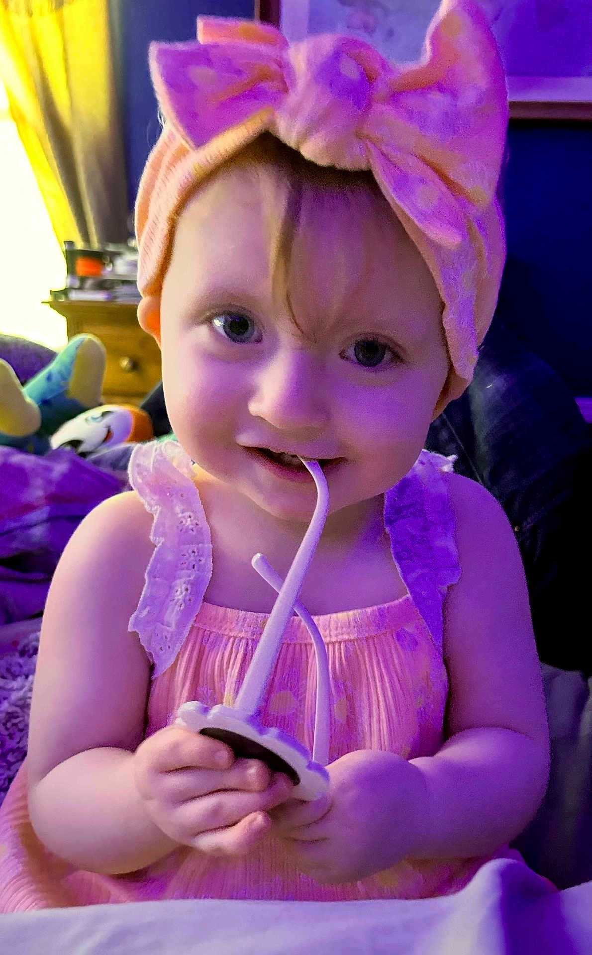 Octavia joined the competition — help win amazing prizes! toddler, child, baby, headband, bow, pink_dress, toy, indoor, smiling, hands, face, curly_hair, playing, purple_light, furniture, bedroom, cute, young_child, portrait, closeup