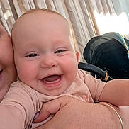 Grace is registered to the contest to win money with this photo: baby, smiling, happy, child, person, arm, hand, stroller, curtains, indoor, closeup, skin, clothing, infant, portrait, cute, joy, family, holding, light