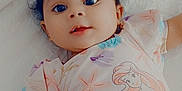 Ashanti is registered to the contest to win money with this photo: baby, infant, child, onesie, mermaid, hand, white_quilt, cute, lying_down, portrait, soft_lighting, indoor, smiling, curly_hair, playful, colorful_clothing, tender_moment, close_up, happy, skin