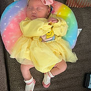 Amira joined the competition — help win amazing prizes! baby, balloon, chair, clothing, costume, couch, cushion, dress, face, furniture, hat, head, homedecor, hosiery, newborn, person, photography, portrait, sleeping, sock