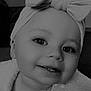 Esme is registered to the contest to win money with this photo: baby, child, smiling, headband, bow, close_up, face, eyes, teeth, infant, portrait, cute, adorable, black_and_white, clothing, soft_texture, young, happy, indoors, person