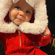 Nova-Rae joined the competition — help win amazing prizes! baby, blue_eyes, bow, child, closeup, cozy, cute, face, fur_trim, happy, hood, indoor, infant, knitwear, portrait, red_clothing, small_hand, smile, warm, winter