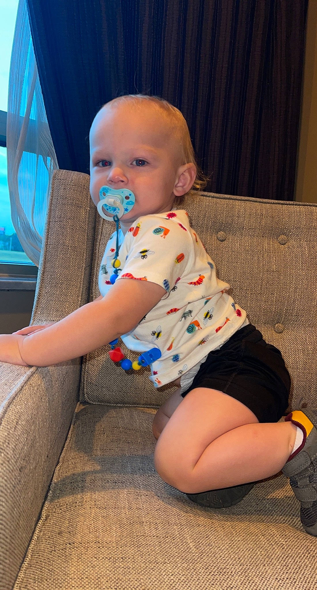 Caysen is registered to the contest to win money with this photo: arm, baby, baby_toddler_clothing, chair, cheek, comfort, eye, face, finger, fun, hairstyle, human_body, human_leg, knee, person, skin, sleeve, sock, standing, thigh