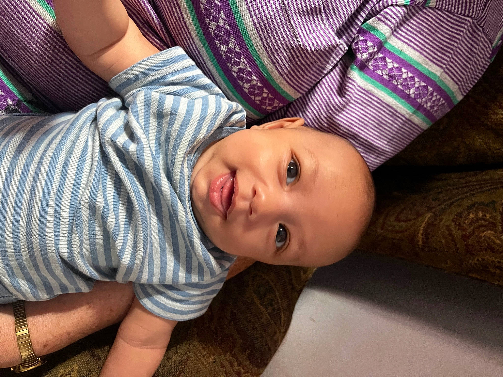 Jabari is registered to the contest to win money with this photo: child, elbow, eye, eyelash, face, fun, hand, happy, head, joint, lip, nose, person, plant, sitting, skin, sleeve, smile, t_shirt, thigh