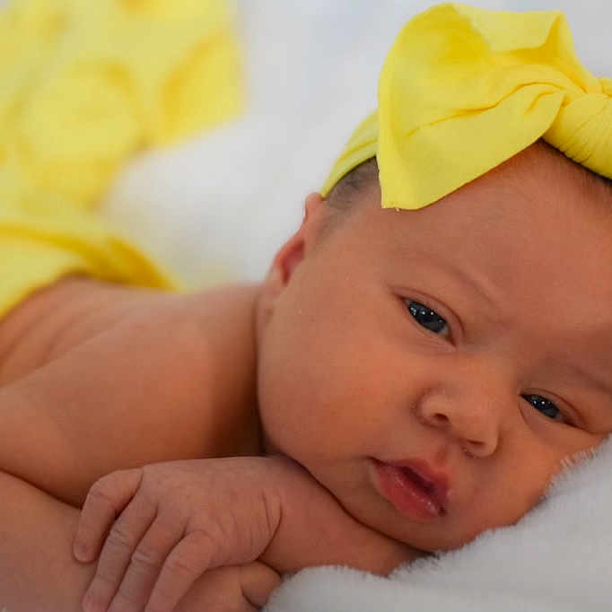 Adilynn is registered to the contest to win money with this photo: baby, bed, blanket, bodypart, bonnet, clothing, face, finger, furniture, hand, happy, hat, head, newborn, person, photography, portrait, sleeping, smile, towel