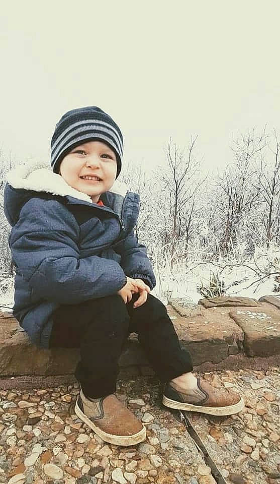 Clay is registered to the contest to win money with this photo: baby, baby_toddler_clothing, beanie, bonnet, child_model, cool, footwear, freezing, headwear, hood, jacket, joy, knit_cap, outdoor_shoe, person, photo_shoot, portrait, portrait_photography, shoe, sitting