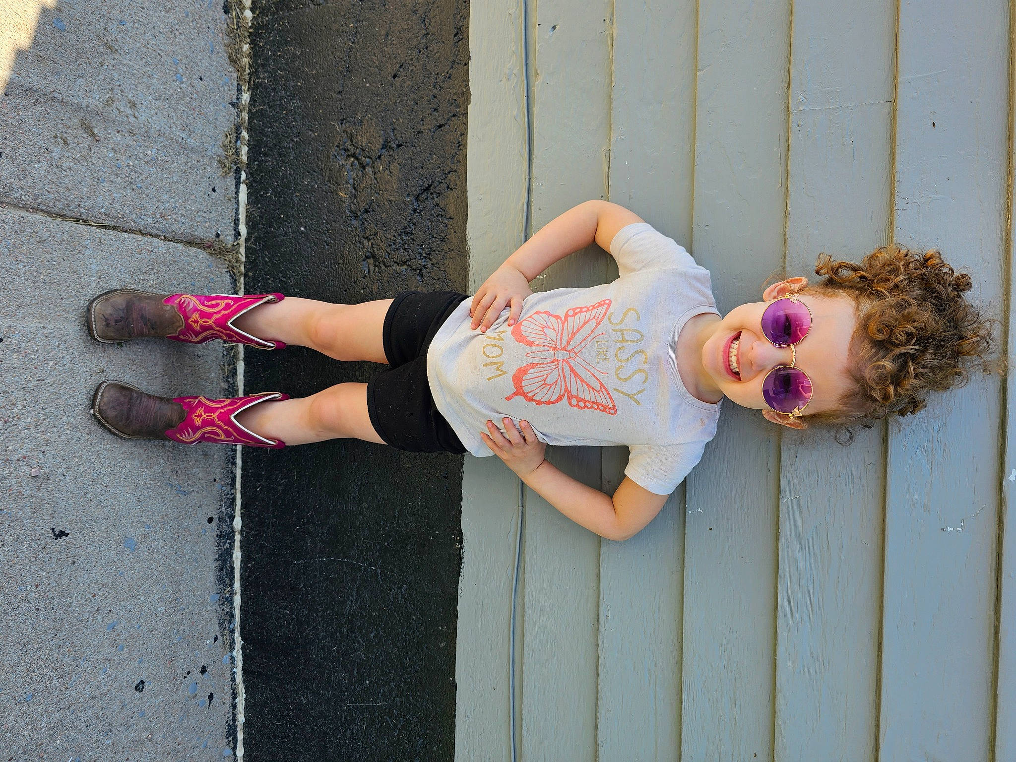 Autumn is registered to the contest to win money with this photo: asphalt, baby_toddler_clothing, calf, concrete, eyewear, foot, human_leg, joy, knee, leg, magenta, pattern, person, pink, road_surface, sandal, sunglasses, thigh, toddler, waist