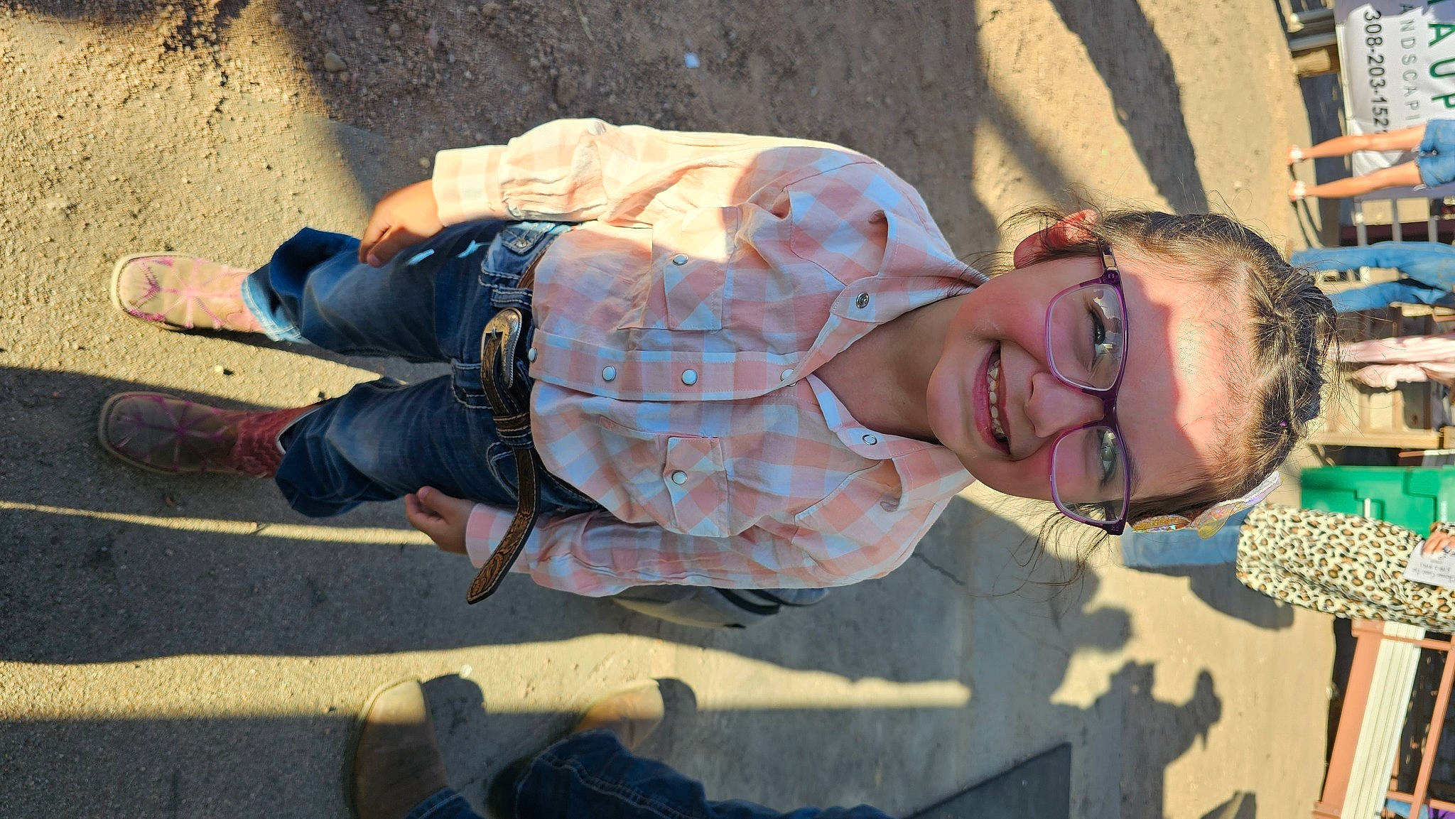Raeleigh is registered to the contest to win money with this photo: eyewear, fun, happy, hat, human_leg, joy, landscape, leisure, pattern, person, sand, shadow, sitting, smile, thigh, tree, vacation, wall