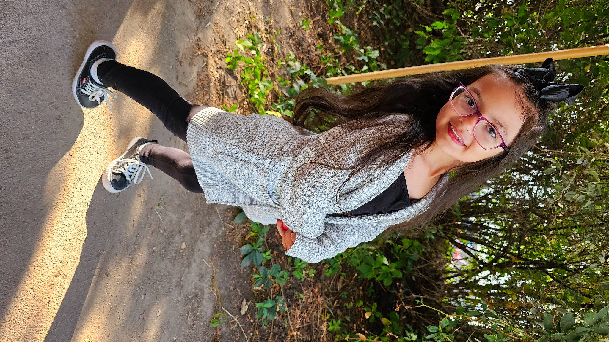 Raeleigh is registered to the contest to win money with this photo: eyewear, flash_photography, fun, grass, happy, human_leg, joy, landscape, leisure, people_in_nature, person, plant, shadow, sitting, smile, soil, sunglasses, thigh, tree, vision_care