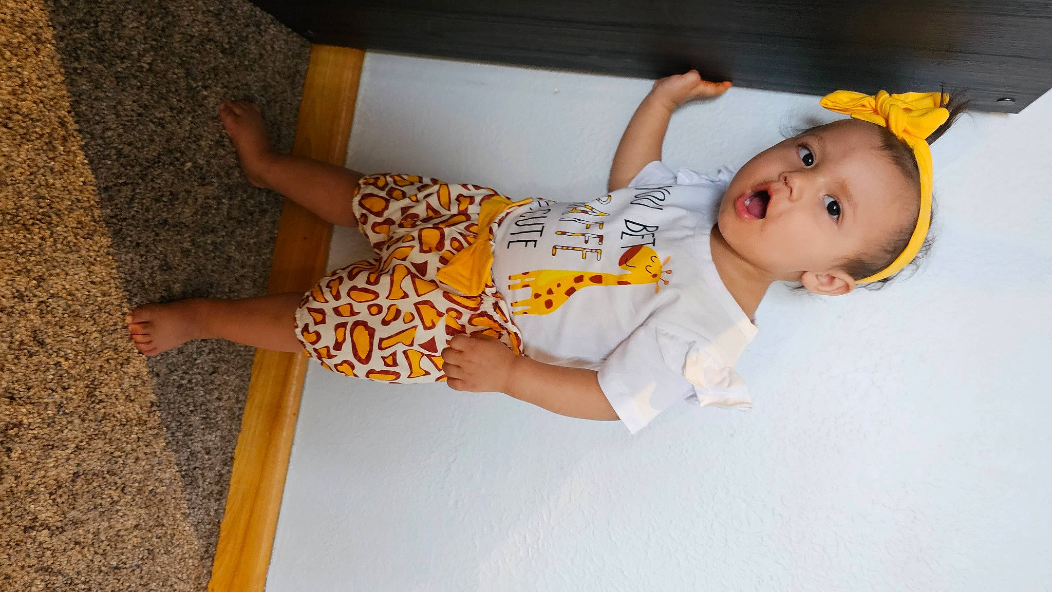 Skylar joined the competition — help win amazing prizes! baby, baby_toddler_clothing, child, comfort, elbow, finger, flooring, foot, fun, happy, human_leg, knee, leg, pattern, person, room, skin, sock, surprise, thigh