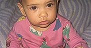Sariah joined the competition — help win amazing prizes! toddler, child, baby, pigtails, pink_shirt, princess_print, bottle, toy, blanket, striped_blanket, indoor, cute, curious, sitting, portrait, young_child, infant, clothing, person, face