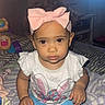 Sariah joined the competition — help win amazing prizes! toddler, child, baby, bow, curly_hair, shirt, bunny_print, blue_pants, bed, blanket, toy, indoor, cute, portrait, sitting, clothing, hand, face, eyes, headband