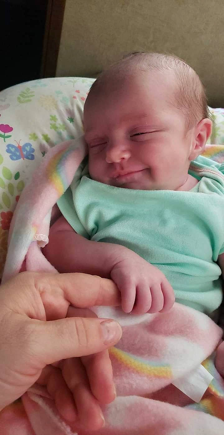 Aryia is registered to the contest to win money with this photo: baby, baby_toddler_clothing, cheek, child, comfort, eyebrow, face, finger, gesture, grass, happy, iris, linens, mouth, nose, person, pink, skin, textile, thumb