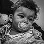 Thomas participe au concours pour gagner de l'argent avec cette photo : baby, infant, pacifier, blanket, soft_toy, curly_hair, black_and_white, close_up, face, child, person, cute, expression, clothing, portrait, newborn, indoors, toddler, holding, comfort