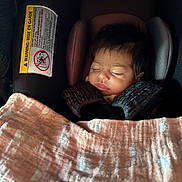 Areli joined the competition — help win amazing prizes! baby, sleeping, car_seat, blanket, infant, child, face, head, hair, safety_harness, pink_blanket, patterned_blanket, cozy, indoor, closeup, peaceful, resting, cute, newborn, seat