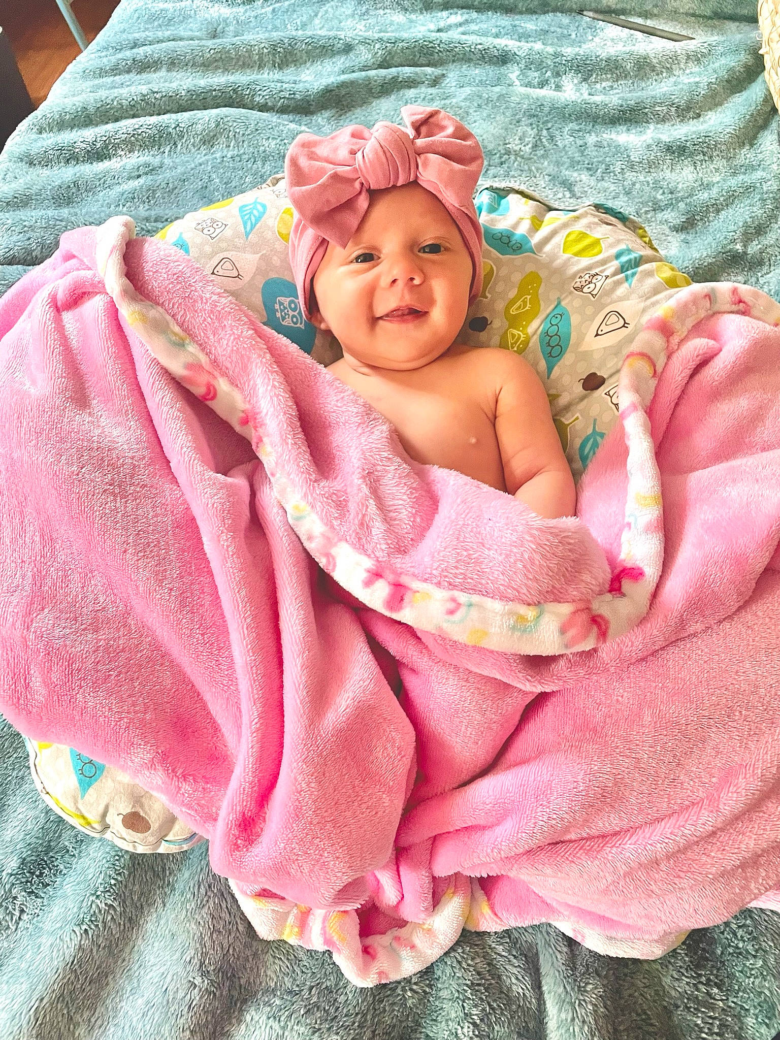 Sydney joined the competition — help win amazing prizes! baby, baby_products, baby_toddler_clothing, bedding, cheek, child, comfort, face, headwear, human_body, infant_bed, iris, linens, magenta, person, pink, skin, sleeve, smile, textile
