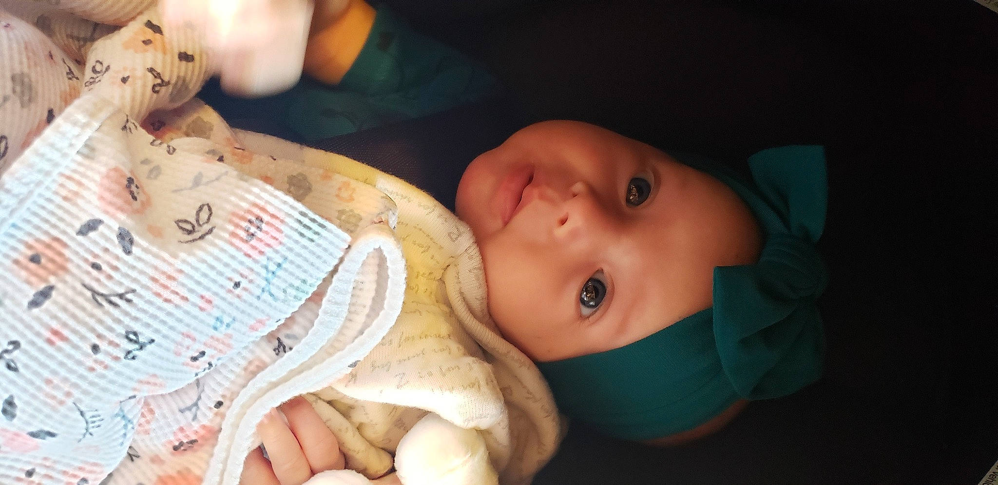 Murphy is registered to the contest to win money with this photo: baby, baby_toddler_clothing, cheek, child, comfort, finger, hand, happy, headgear, headwear, iris, linens, lip, mammal, mouth, nose, organ, person, room, skin