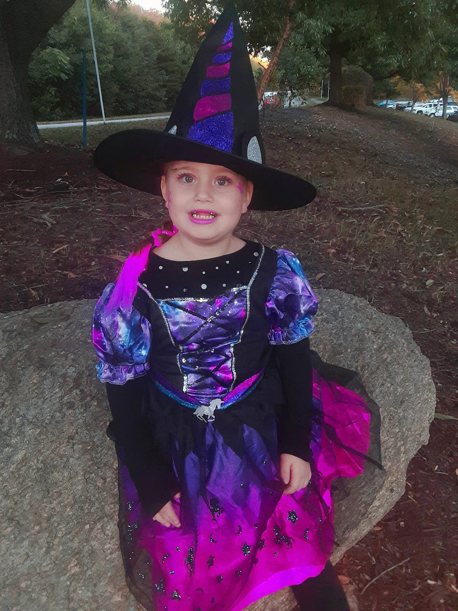 Angel is registered to the contest to win money with this photo: baby_toddler_clothing, cone, costume_hat, event, fashion_accessory, fun, grass, hat, headgear, headwear, joy, magenta, party_hat, person, pink, plant, purple, smile, toddler, tradition