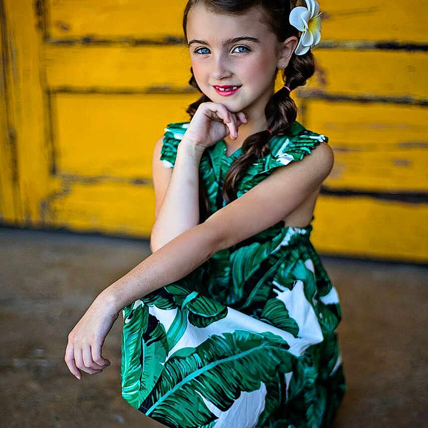 Preslie is registered to the contest to win money with this photo: child, child_model, dress, fashion_design, green, joy, person, photo_shoot, photography, shoulder, sitting, smile, trunk, yellow