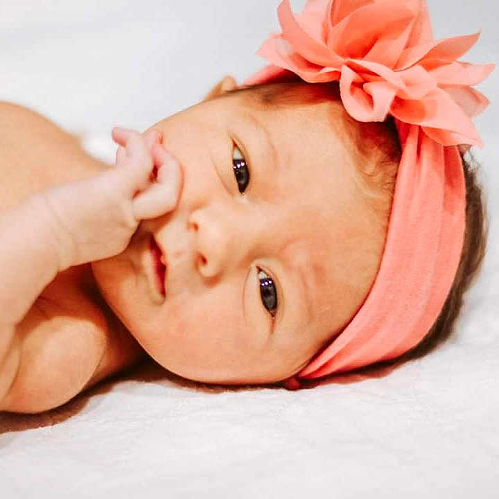 Caylee joined the competition — help win amazing prizes! baby, cheek, child, close_up, eye, face, hair_accessory, hand, head, headband, headgear, headpiece, lip, mouth, nose, photography, pink, portrait_photography, skin, toddler