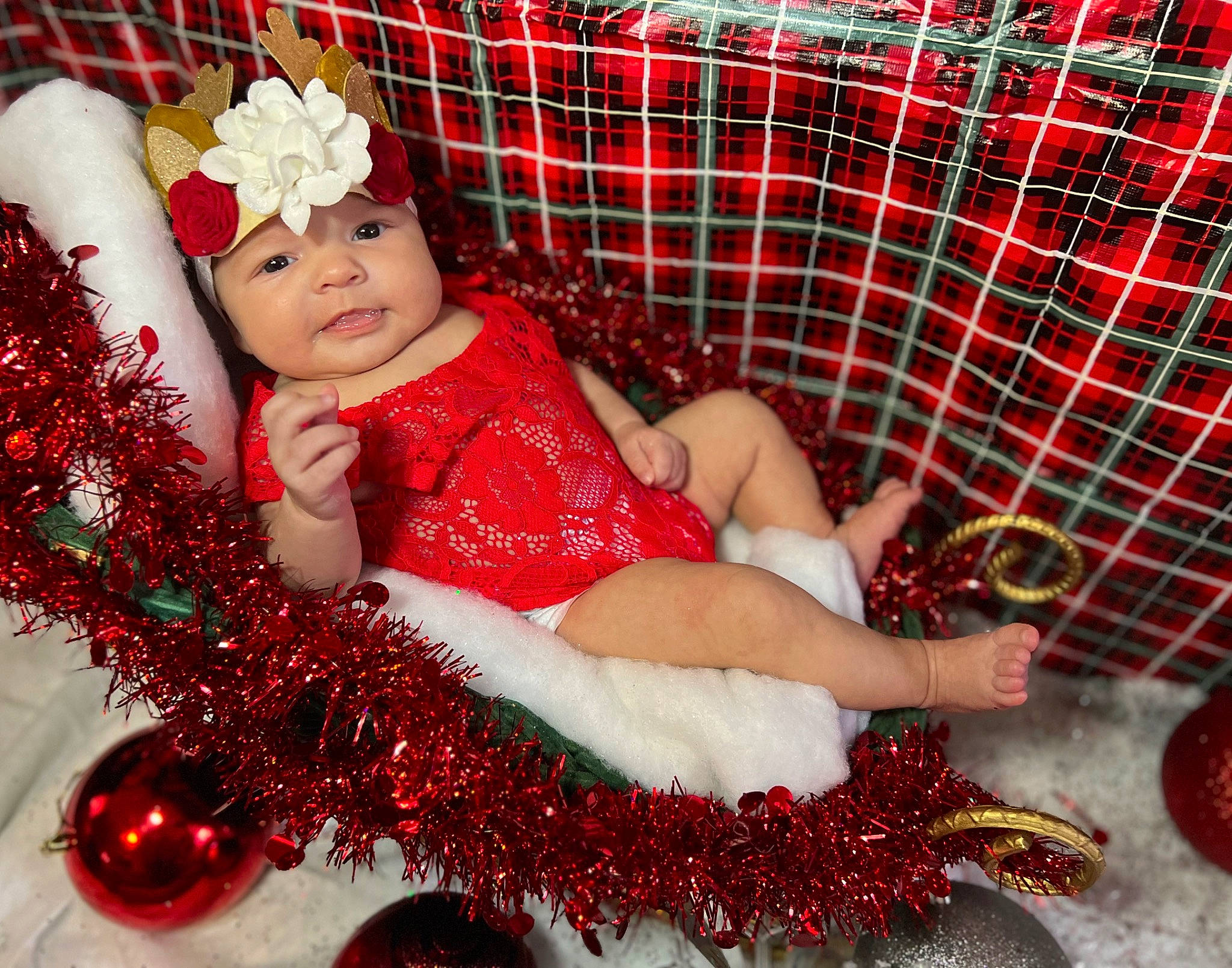 Harmoney is registered to the contest to win money with this photo: baby, baby_toddler_clothing, carmine, embellishment, event, fashion_accessory, happy, headpiece, headwear, human_body, jewellery, lap, magenta, pattern, person, petal, pink, plaid, red, tartan